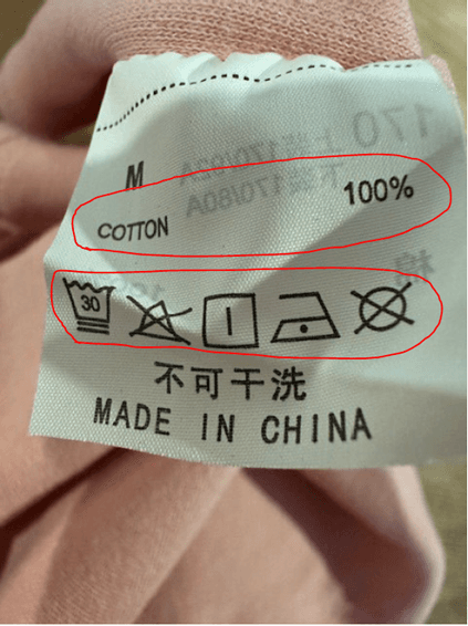 "Cotton 100%" and the care instructions are printed on the sewn-in seam label