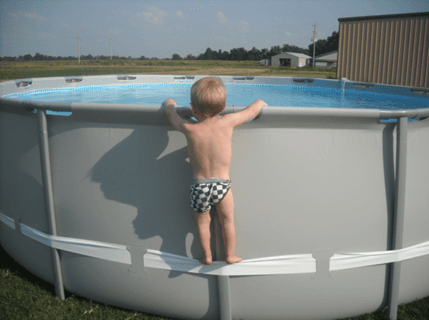 Example of child using the compression strap to stand on above-ground pool, illustrating the hazard involved