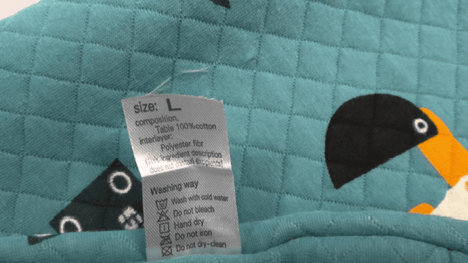 "100% cotton" and the garment size are printed on a sewn-in side seam label