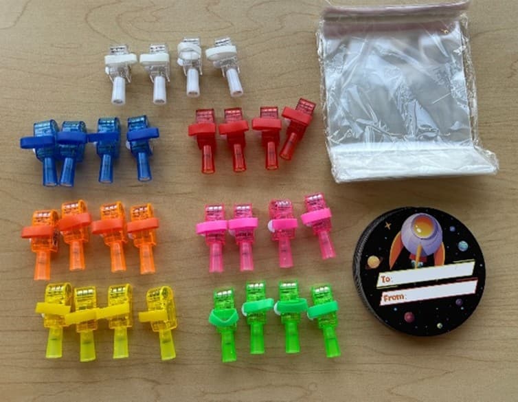 The recalled Syera Space Astronaut finger lights have three internal button cell batteries that power astronaut projections